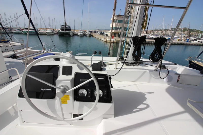  Yacht Photos Pics Helm of 2022 Bali 4.6 yacht in marina, featuring navigation equipment and steering wheel.