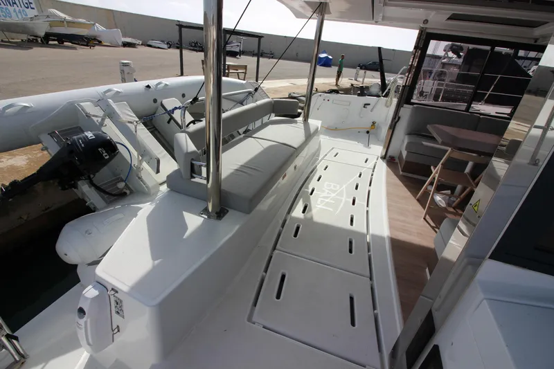  Yacht Photos Pics 2022 Bali 4.6 yacht deck with seating and dining area, docked at marina.