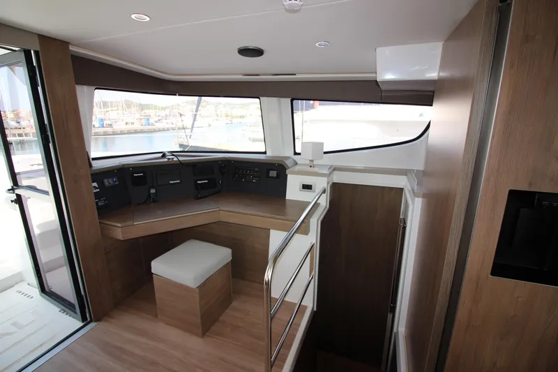  Yacht Photos Pics Modern interior of 2022 Bali 4.6 yacht with helm station and wooden finishes.