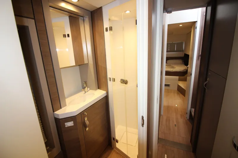  Yacht Photos Pics Modern bathroom interior in 2022 Bali 4.6 yacht, featuring sleek design and wooden accents.
