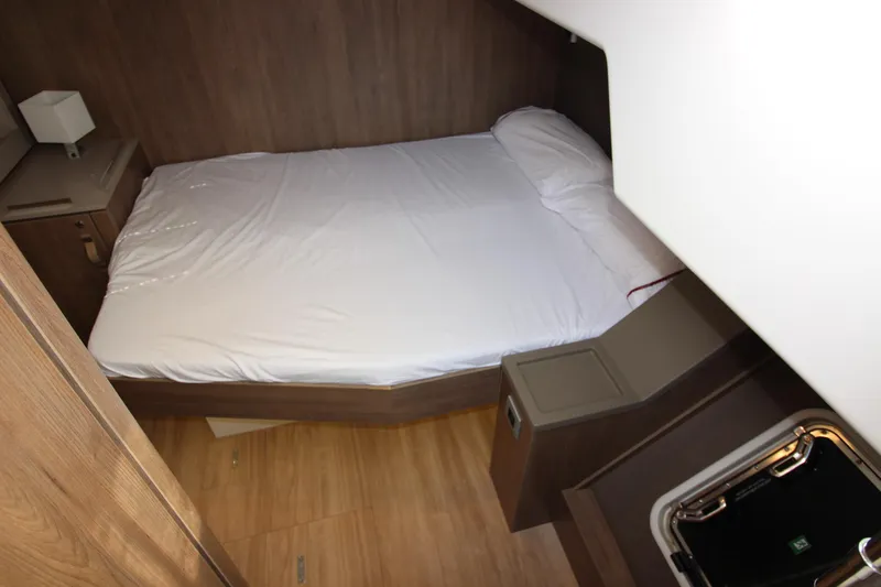  Yacht Photos Pics Cozy cabin interior of 2022 Bali 4.6 yacht with bed and wooden furnishings.