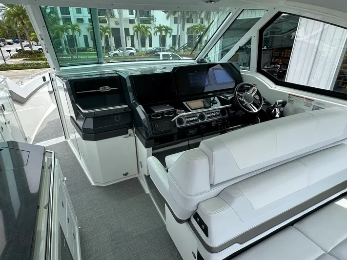  Yacht Photos Pics 2021 Formula 380 SSC boat cockpit with modern navigation system and white seating.