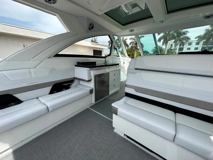  Yacht Photos Pics 2021 Formula 380 SSC boat interior with white seating and kitchenette.