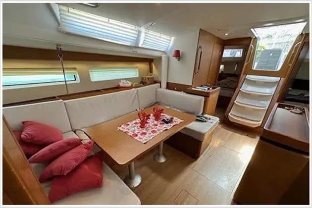  Yacht Photos Pics Interior of 2020 Jeanneau Sun Odyssey 490 yacht with cozy seating and dining area.