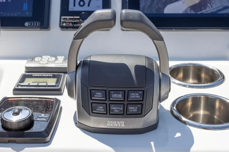  Yacht Photos Pics Control panel of a 2021 Prestige 520 yacht featuring Volvo Penta throttle and navigation controls.