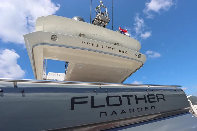  Yacht Photos Pics Luxury yacht Prestige 520, 2021 model, with "Flother Naarden" branding against blue sky.