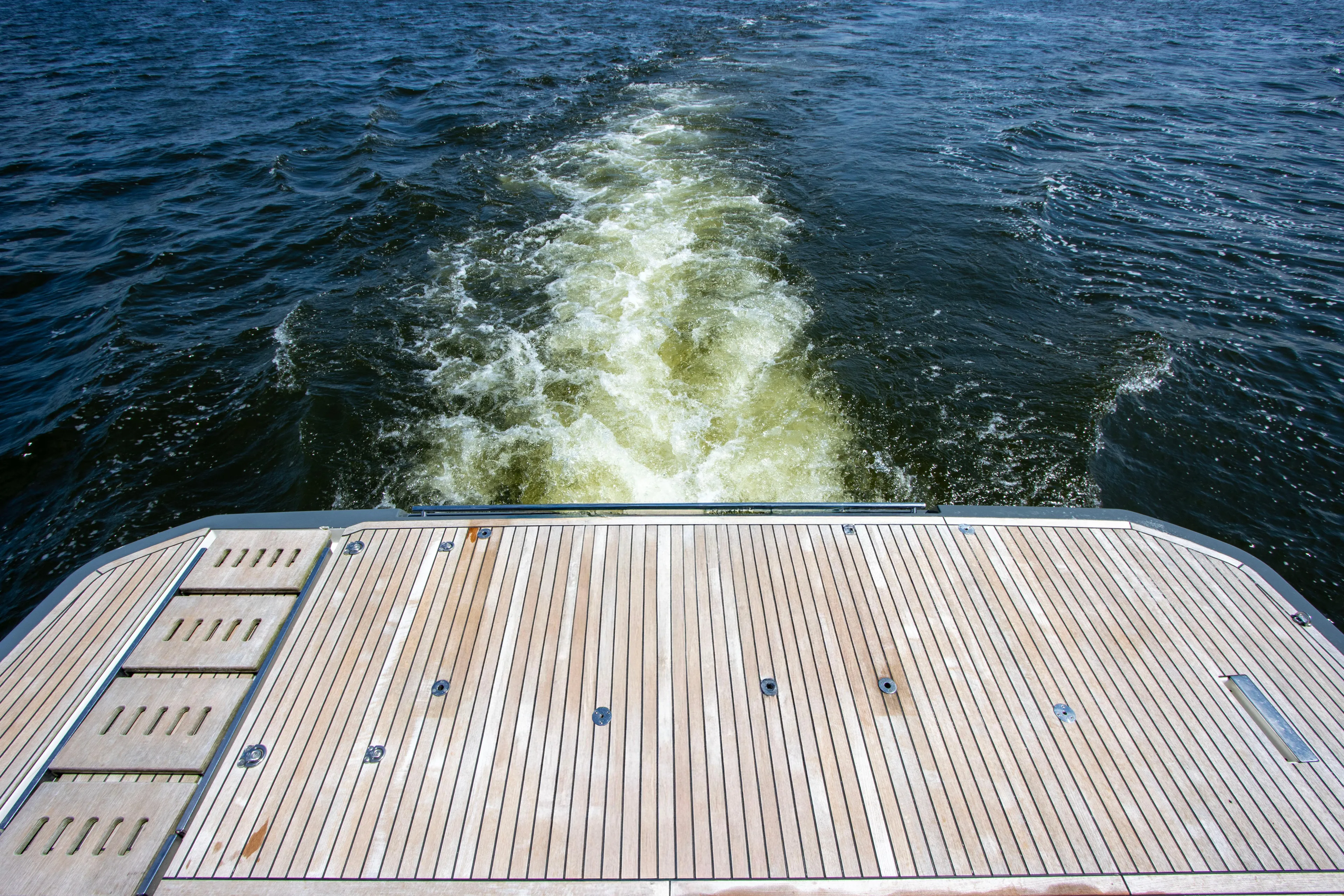  Yacht Photos Pics Teak deck of 2021 Prestige 520 yacht with ocean wake view.