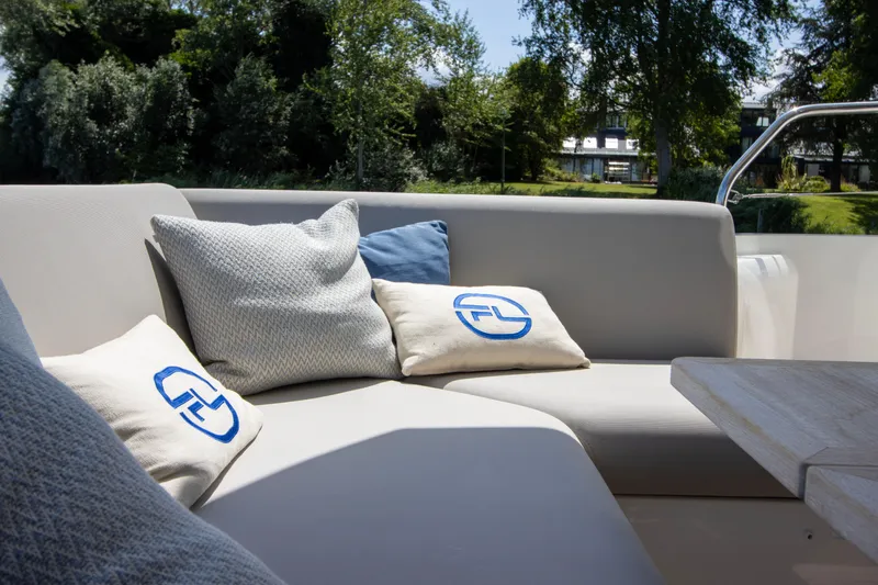  Yacht Photos Pics Luxurious seating area on a 2021 Prestige 520 yacht with plush cushions and scenic view.