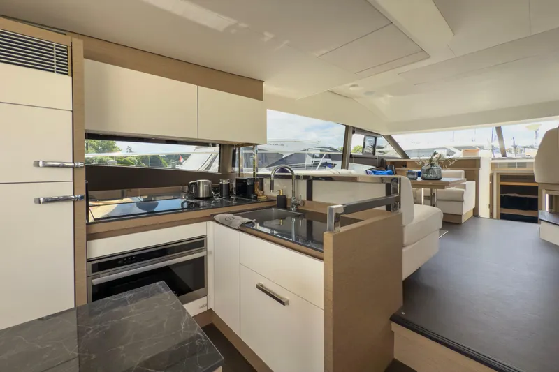  Yacht Photos Pics Luxurious interior of 2021 Prestige 520 yacht featuring modern kitchen and seating area.