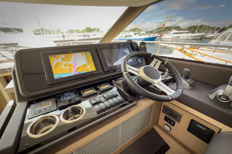  Yacht Photos Pics Helm of 2021 Prestige 520 yacht with navigation screens and steering wheel.