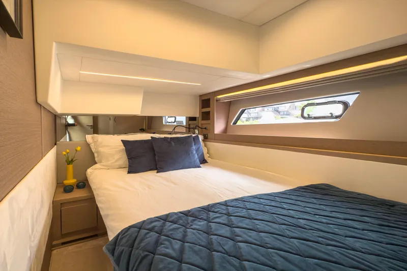  Yacht Photos Pics Luxurious bedroom interior of 2021 Prestige 520 yacht with modern design and cozy bedding.