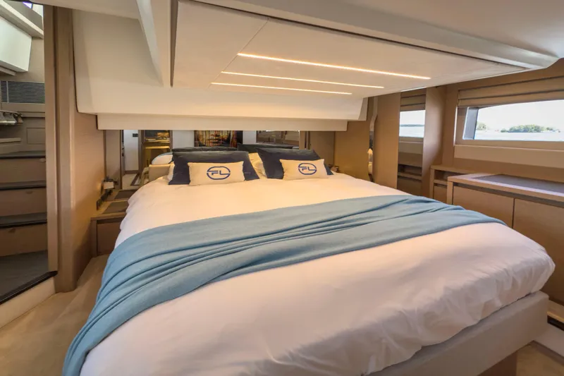  Yacht Photos Pics Luxurious bedroom interior of 2021 Prestige 520 yacht with modern design and cozy bedding.
