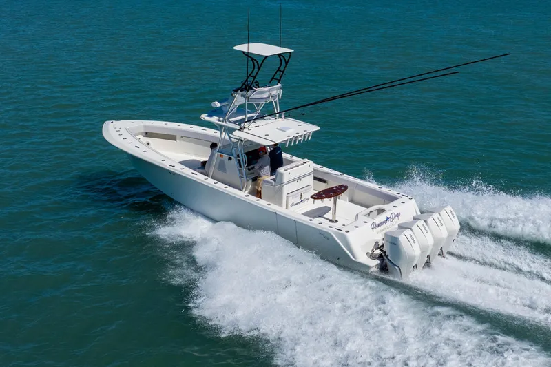  Yacht Photos Pics 2012 SeaVee 390B boat cruising on open water with triple outboard engines.