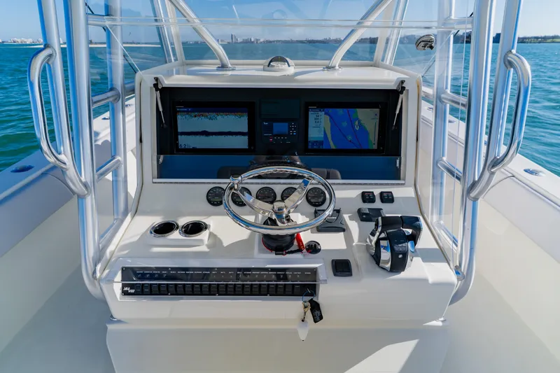  Yacht Photos Pics 2012 SeaVee 390B boat dashboard with navigation screens and steering wheel on open water.
