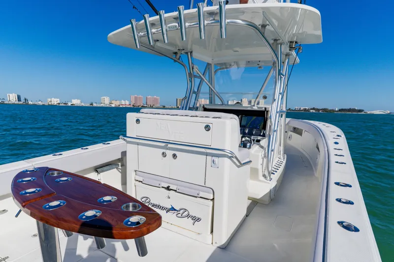  Yacht Photos Pics 2012 SeaVee 390B boat on water, featuring fishing rod holders and city skyline.