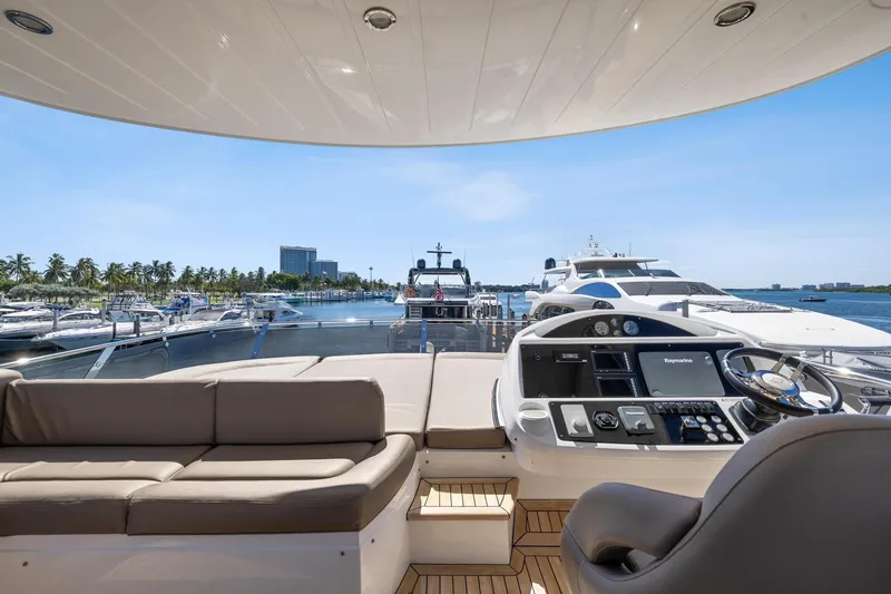  Yacht Photos Pics Luxurious 2014 Sunseeker 73 Manhattan yacht interior with helm and seating, docked in marina.