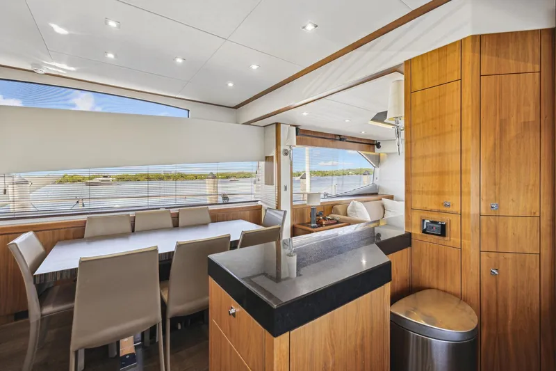  Yacht Photos Pics Luxurious interior of 2014 Sunseeker 73 Manhattan yacht with dining area and modern wood finishes.