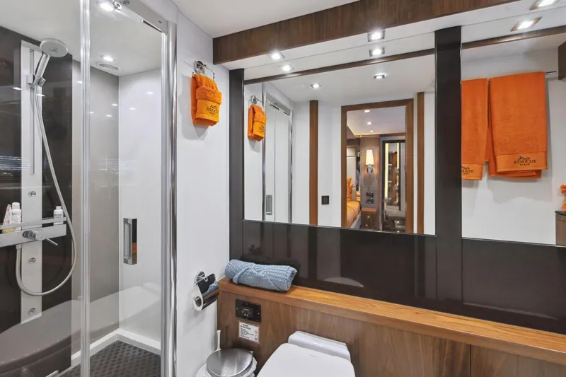  Yacht Photos Pics Luxurious bathroom in 2014 Sunseeker 73 Manhattan yacht with modern shower and orange towels.