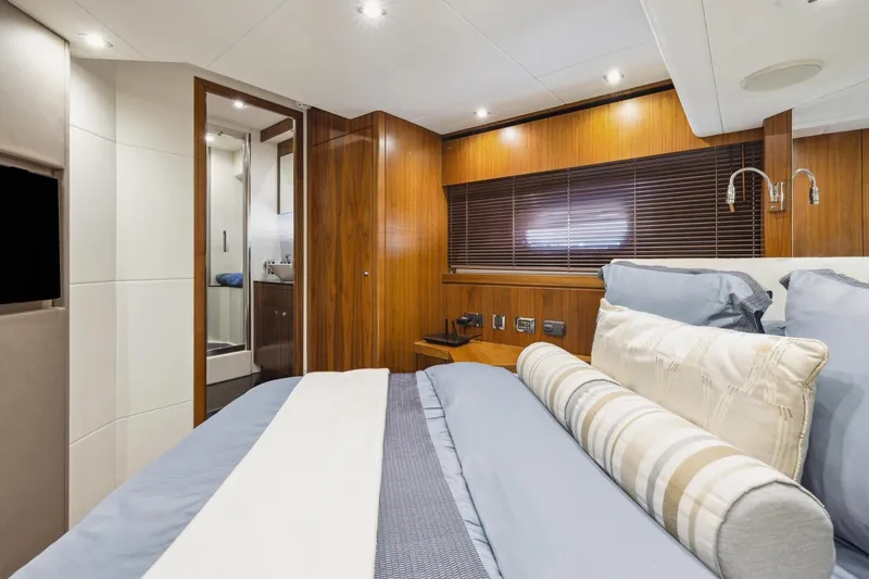  Yacht Photos Pics Luxurious bedroom interior of 2014 Sunseeker 73 Manhattan yacht with elegant wood paneling.