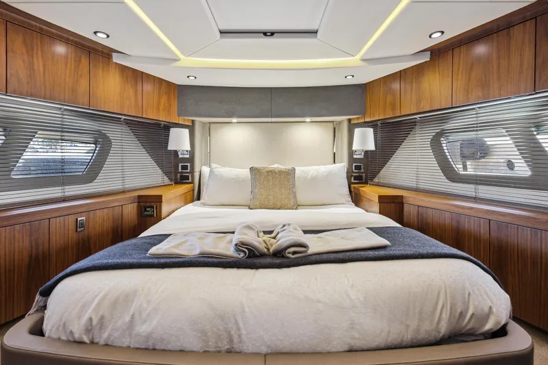  Yacht Photos Pics Luxurious bedroom interior of 2014 Sunseeker 73 Manhattan yacht with elegant wood finishes.