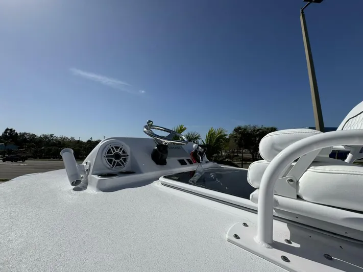  Yacht Photos Pics 2025 Sportsman 302cc boat deck with seating and speaker, under clear blue sky.