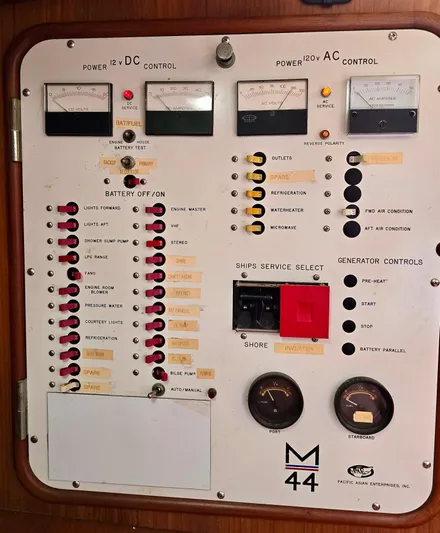 Circa Tempo Yacht Photos Pics Electrical control panel of a 1991 Mason 44 boat with various switches and gauges.
