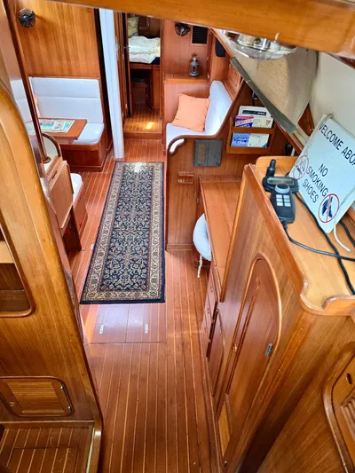Circa Tempo Yacht Photos Pics Interior of 1991 Mason 44 yacht with wooden finish and cozy seating area.