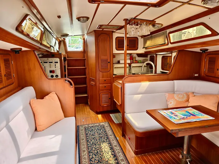 Circa Tempo Yacht Photos Pics Luxurious 1991 Mason 44 yacht interior with wood finish, cozy seating, and modern amenities.
