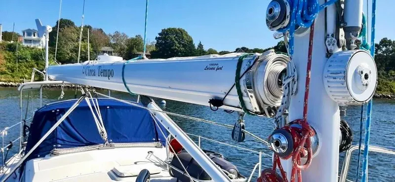 Circa Tempo Yacht Photos Pics Sailboat deck with mast and rigging, Mason 44 model, 1991, docked near lush shoreline.