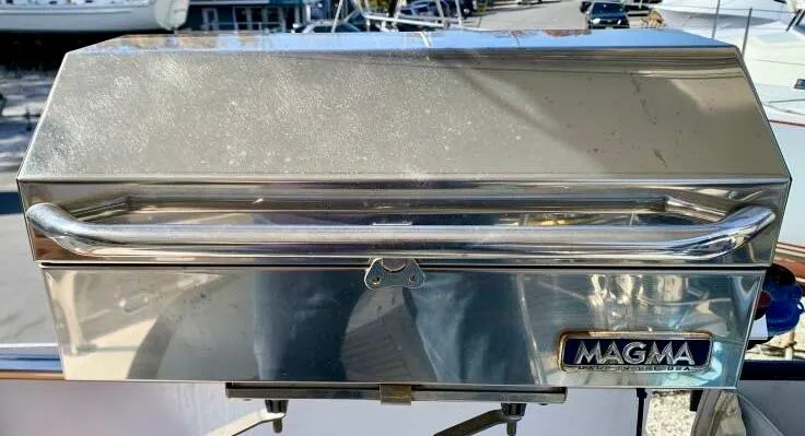Circa Tempo Yacht Photos Pics Stainless steel Magma grill on a boat deck, reflecting sunlight.