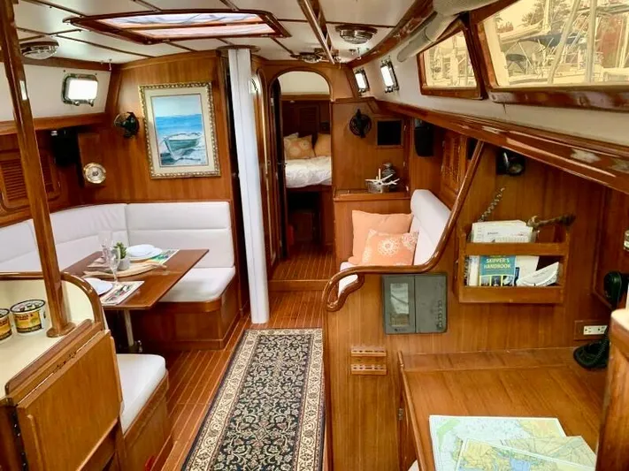 Circa Tempo Yacht Photos Pics Luxurious 1991 Mason 44 yacht interior with wood finish, dining area, and cozy cabin.