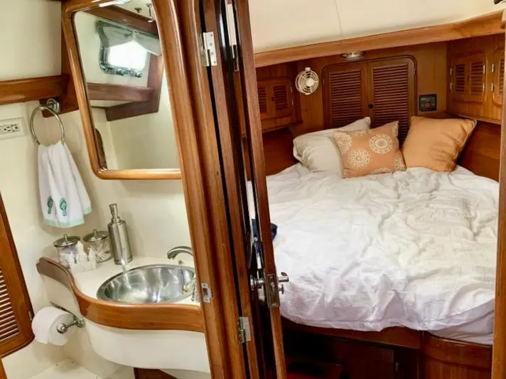 Circa Tempo Yacht Photos Pics Cozy cabin interior of 1991 Mason 44 yacht with bed and compact bathroom.