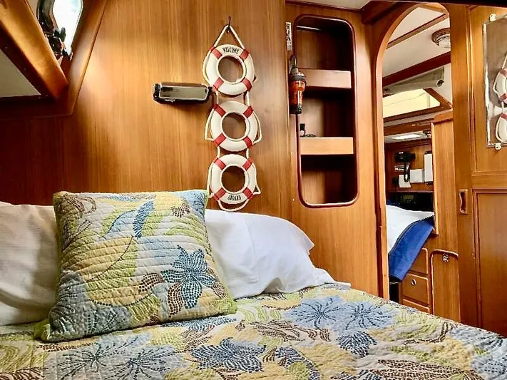 Circa Tempo Yacht Photos Pics Cozy cabin interior of 1991 Mason 44 yacht with nautical decor and colorful bedding.