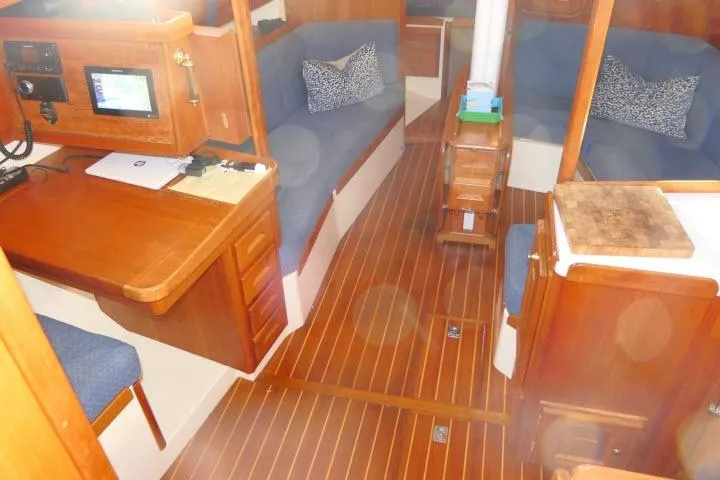 C Otter Yacht Photos Pics Luxurious interior of 2002 Tartan 3700 sailboat with wooden flooring and cozy seating.