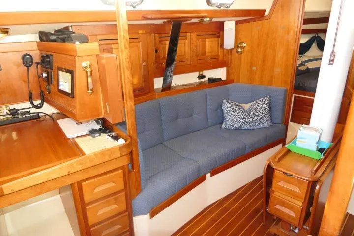 C Otter Yacht Photos Pics Interior of 2002 Tartan 3700 sailboat with blue sofa and wooden cabinetry.