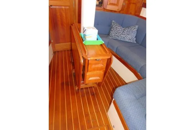 C Otter Yacht Photos Pics Interior of 2002 Tartan 3700 sailboat with wooden flooring and blue seating.