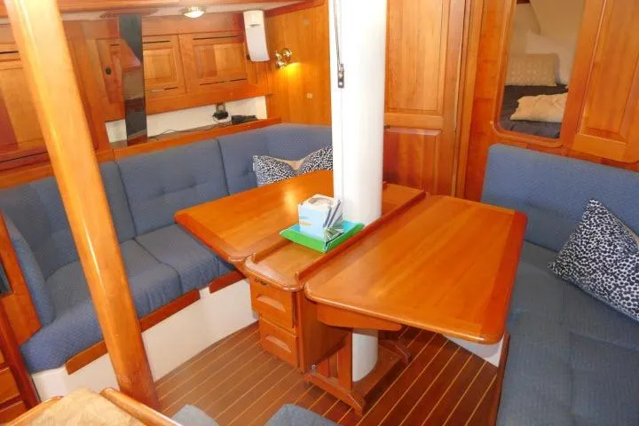 C Otter Yacht Photos Pics Interior of 2002 Tartan 3700 sailboat with wooden furnishings and blue seating.