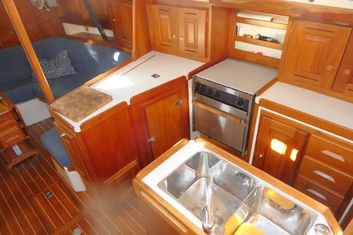 C Otter Yacht Photos Pics Interior of 2002 Tartan 3700 sailboat with wooden cabinetry and kitchen amenities.
