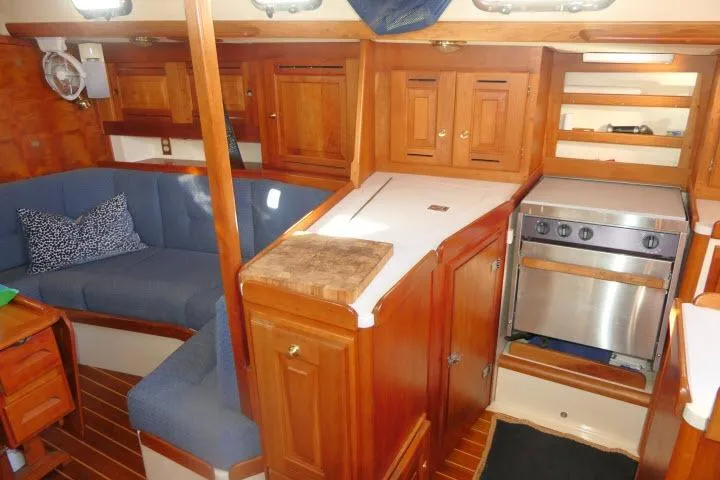 C Otter Yacht Photos Pics Interior of 2002 Tartan 3700 sailboat with wooden cabinetry and cozy seating area.