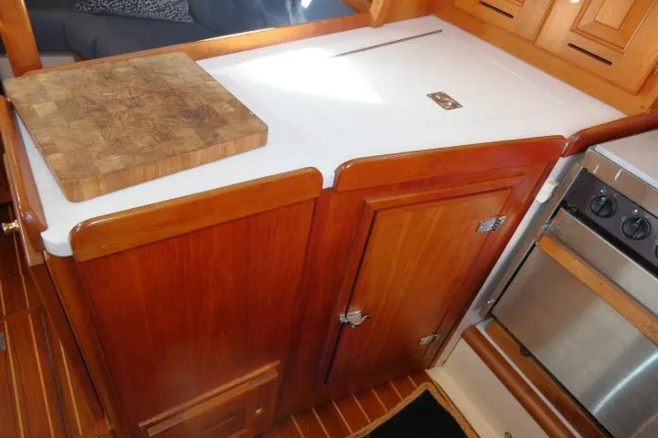 C Otter Yacht Photos Pics Wooden galley kitchen in 2002 Tartan 3700 yacht with cutting board and stove.