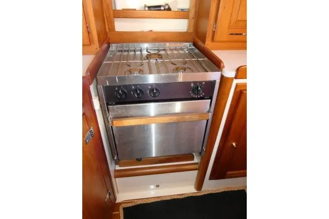 C Otter Yacht Photos Pics Stainless steel stove in 2002 Tartan 3700 yacht kitchen with wooden cabinetry.