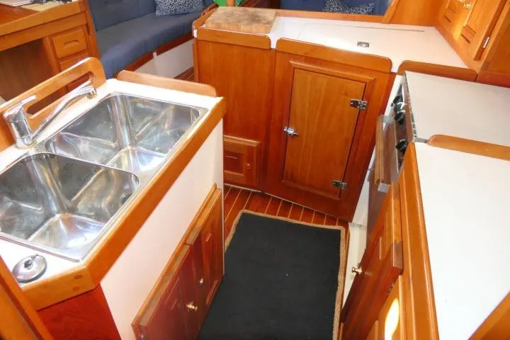 C Otter Yacht Photos Pics 2002 Tartan 3700 yacht interior with wooden cabinetry and dual sink.