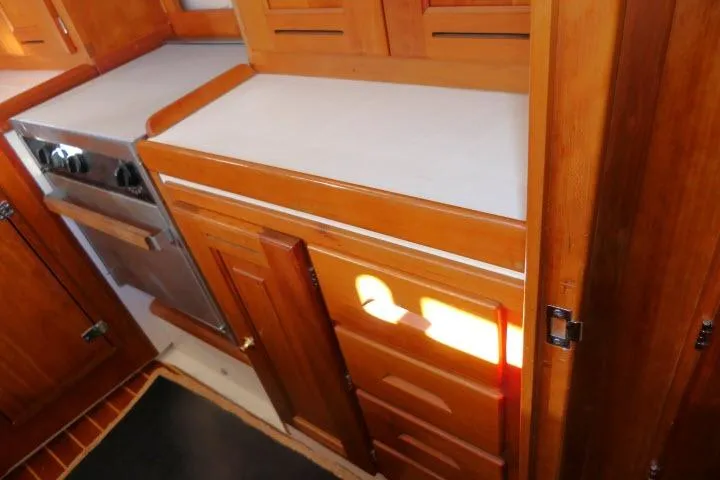C Otter Yacht Photos Pics Wooden kitchen interior of 2002 Tartan 3700 yacht with stove and cabinets.