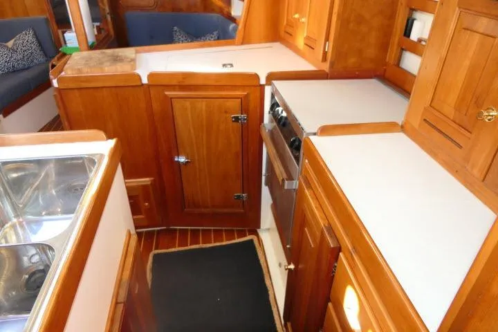 C Otter Yacht Photos Pics Interior of 2002 Tartan 3700 sailboat with wooden cabinetry and compact kitchen area.
