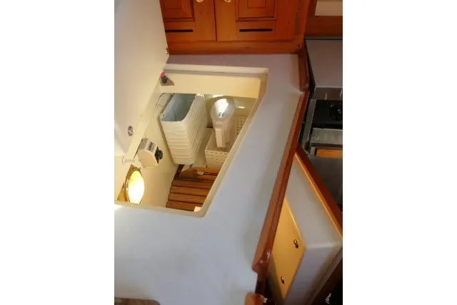 C Otter Yacht Photos Pics Interior view of 2002 Tartan 3700 sailboat, featuring wooden cabinetry and storage area.