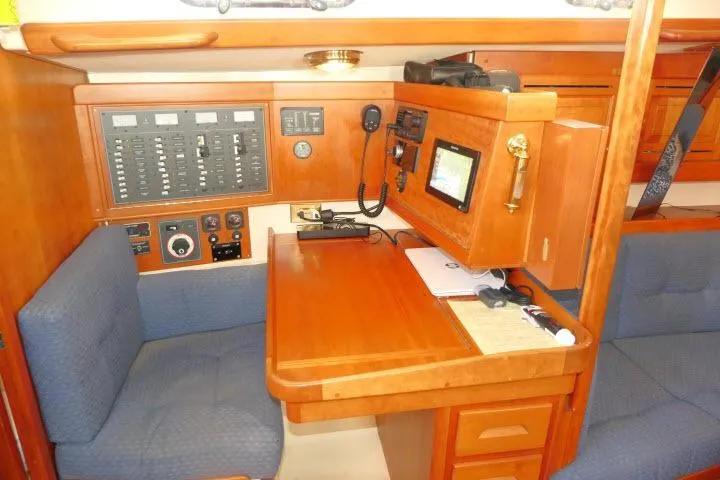 C Otter Yacht Photos Pics Navigation station in 2002 Tartan 3700 sailboat with control panels and seating.
