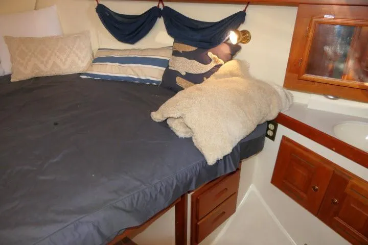 C Otter Yacht Photos Pics Cozy cabin interior of 2002 Tartan 3700 sailboat with bed and wooden cabinets.