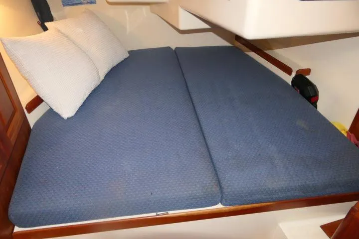 C Otter Yacht Photos Pics Interior cabin of 2002 Tartan 3700 sailboat with blue bedding and pillows.