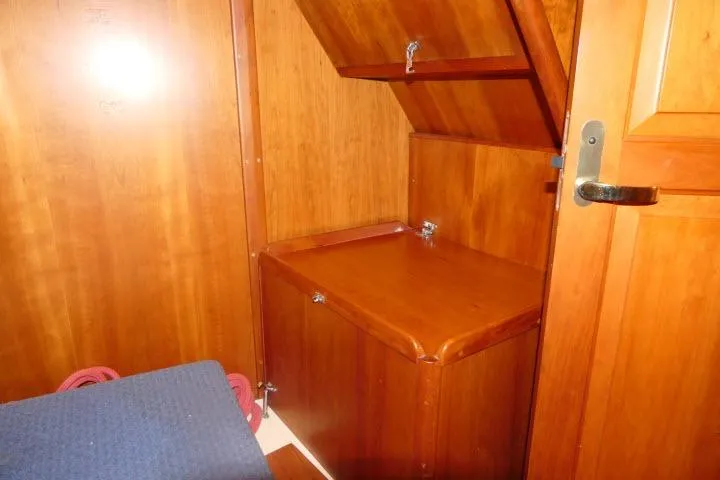 C Otter Yacht Photos Pics Wooden interior of a 2002 Tartan 3700 sailboat, featuring storage compartments and a door.