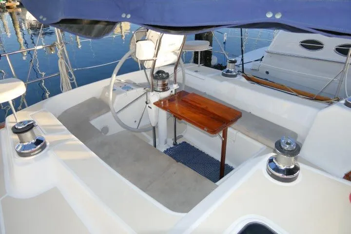 C Otter Yacht Photos Pics Cockpit of 2002 Tartan 3700 sailboat with steering wheel and wooden table.